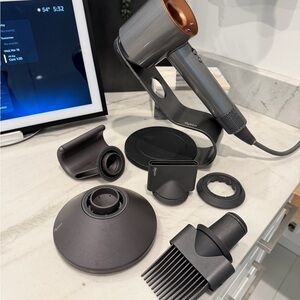 Dyson Silver and Black Hair Dryer with Attachments and Dyson magnetic Stand